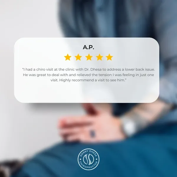 A person in a blue shirt with a blurred background, displaying a positive customer testimonial for chiropractic service by Danny Dhesa Chiropractor.