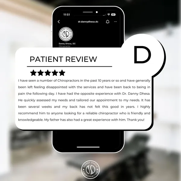 A smartphone displaying a positive patient review for Danny Dhesa Chiropractor on a website, with a translucent letter 'd' overlay.